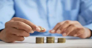Hands stacking coins to illustrate effective lending methods.