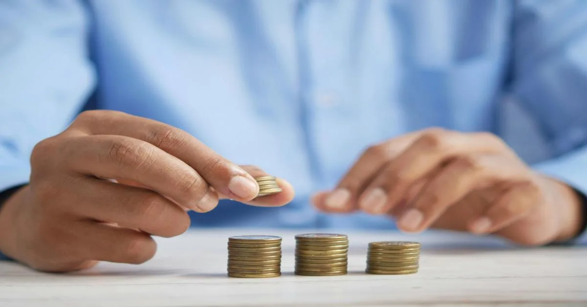 Hands stacking coins to illustrate effective lending methods.