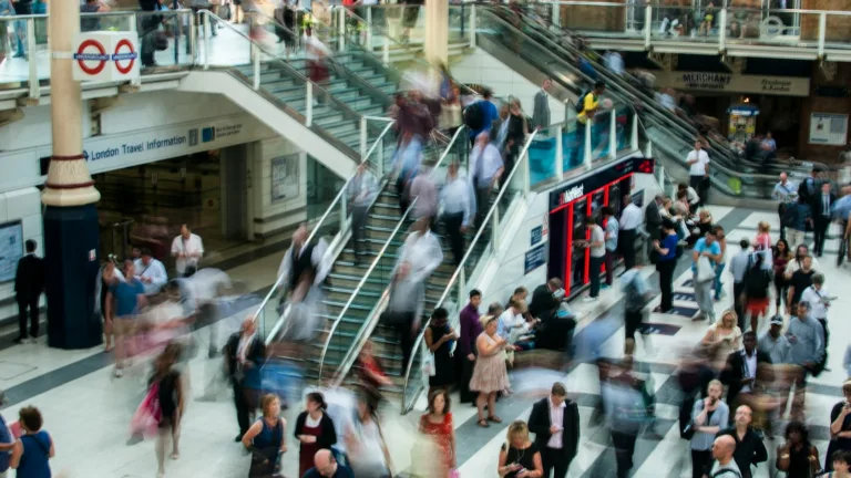 people standing and walking on stairs in mall