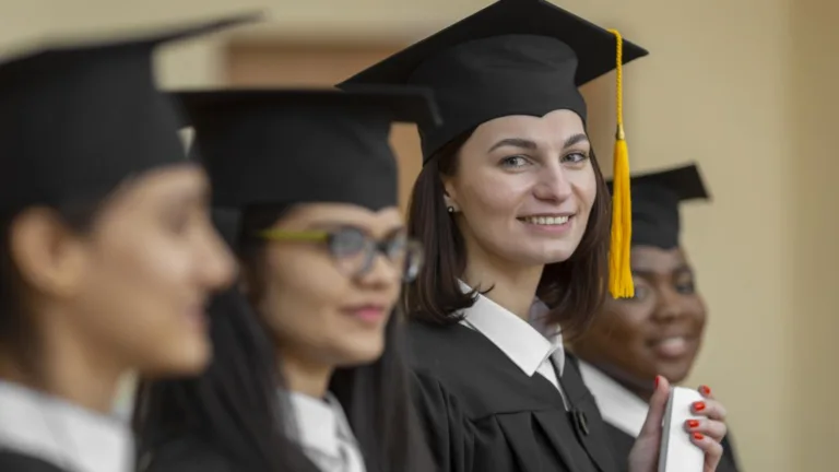 Diverse group of college graduates in caps and gowns at commencement ceremony