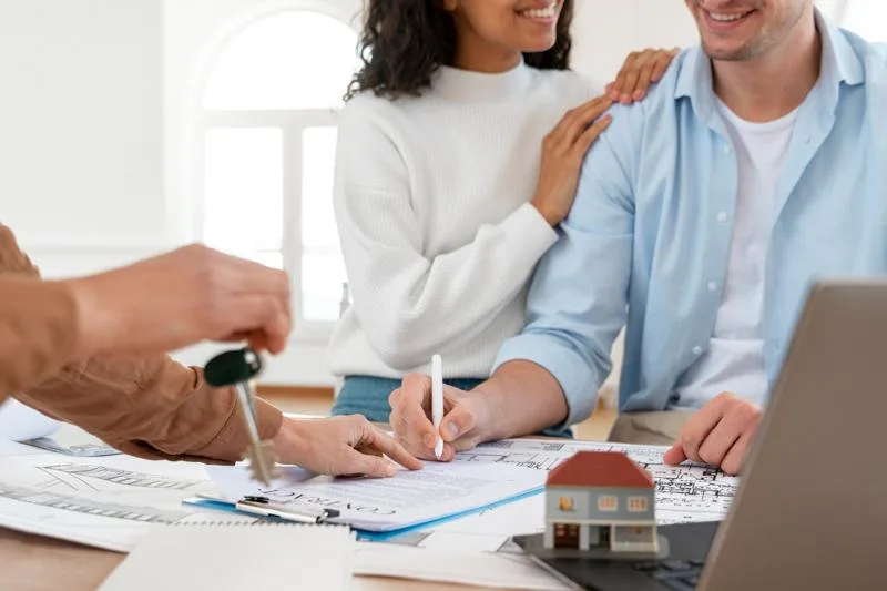 A couple signing a property deal supported by hard money financing