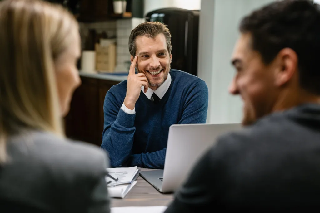 Loan officer smiling while communicating clearly with commercial lending clients.