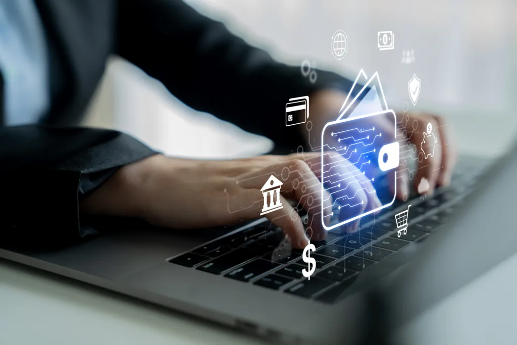 Hands typing on a laptop with digital banking and payment icons overlayed.