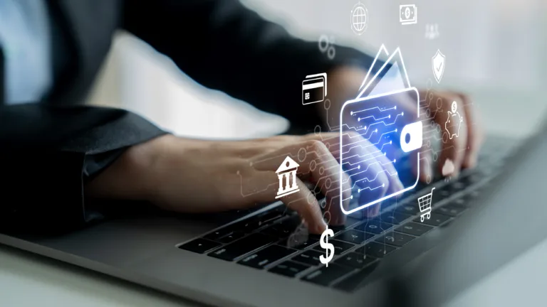 Hands typing on a laptop with digital banking and payment icons overlayed.