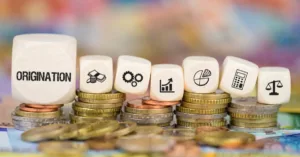 Financial lending and loan origination concepts represented by business icons on wood blocks and stacked coins.