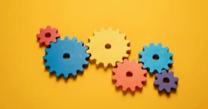 Colorful interlocking gears representing loan processing workflow stages and automation.