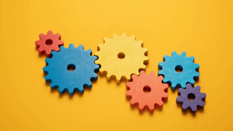 Colorful interlocking gears representing loan processing workflow stages and automation.