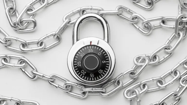 Combination padlock wrapped in metal chains symbolizing security, accuracy, and protection in lockbox payment processing.