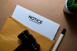 Legal notice document with a gavel, symbolizing compliance requirements for Notice of Right to Cure letters.