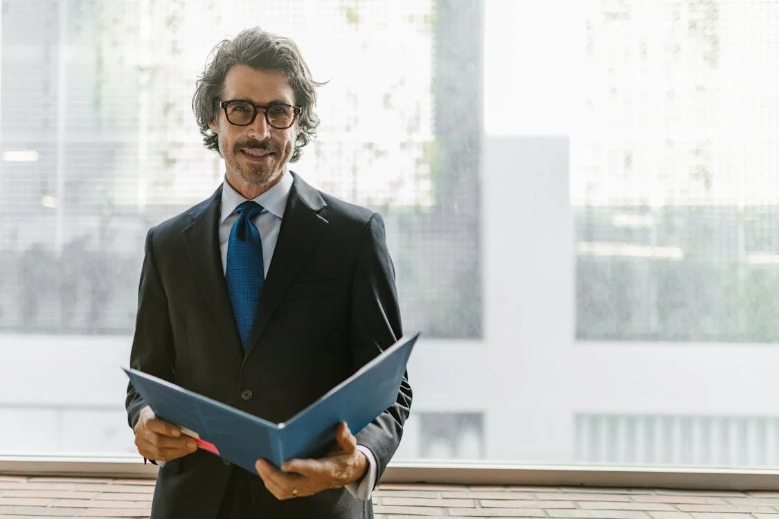 man holding a portfolio loan document in a folder