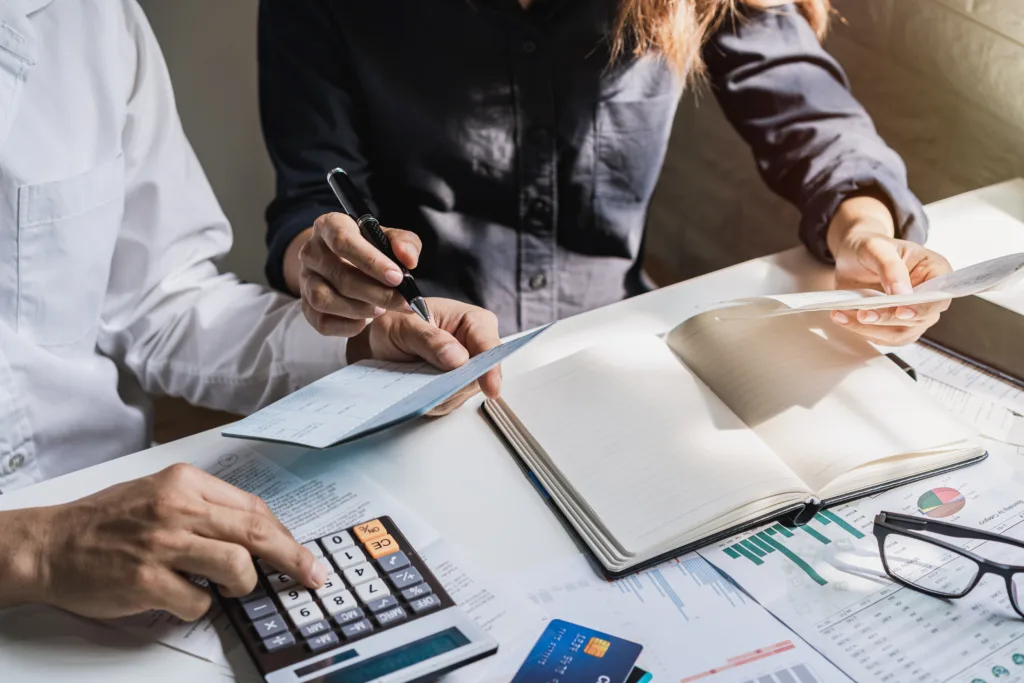 Two professionals reviewing financial documents during the credit underwriting process.