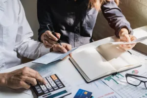 Two professionals reviewing financial documents during the credit underwriting process.