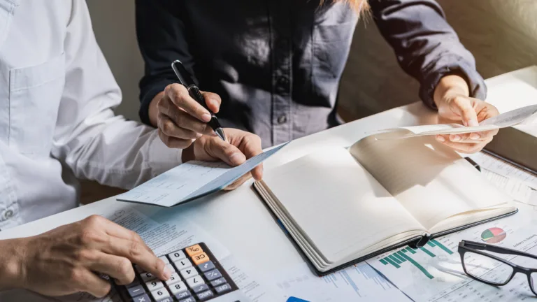 Two professionals reviewing financial documents during the credit underwriting process.