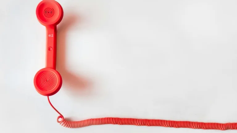 Red retro phone symbolizes call regulations and TCPA dialing restrictions.