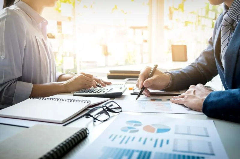 Reviewing loan participation agreement details with charts and calculations