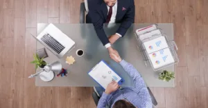 Businessmen shaking hands, discussing what is a participation loan.