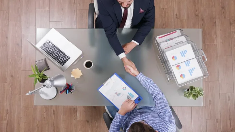Businessmen shaking hands, discussing what is a participation loan.
