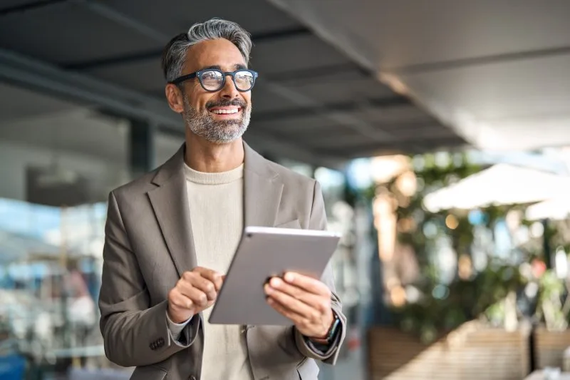 Loan servicing professional using a tablet to monitor portfolio performance and borrower accounts. 